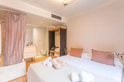 a bedroom with a white bed and a bathroom at My Space Barcelona Pool City Center in Barcelona