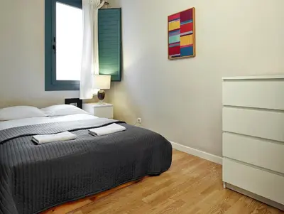 a bedroom with a bed with two towels on it at Barcelona Mercaders Apartments in Barcelona