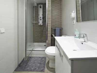 a bathroom with a toilet and a sink and a shower at Barcelona Mercaders Apartments in Barcelona