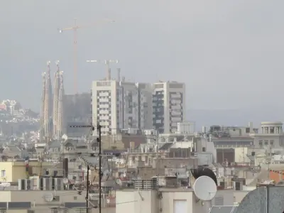 a city skyline with tall buildings and a crane at Barcelona Mercaders Apartments in Barcelona