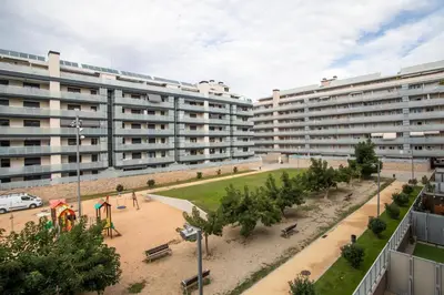 a large apartment building with a playground in front of it at Tendency Apartments Forum in Sant Adria de Besos