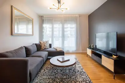 a living room with a couch and a flat screen tv at Tendency Apartments Forum in Sant Adria de Besos
