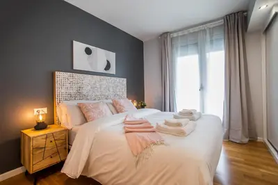 a bedroom with a bed with towels on it at Tendency Apartments Forum in Sant Adria de Besos