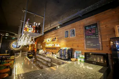 a bar in a restaurant with a counter with drinks at Gatell Hotel in Vilanova i la Geltrú