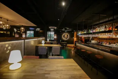 a restaurant with a bar with a table and chairs at Gatell Hotel in Vilanova i la Geltrú