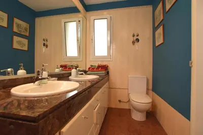 a bathroom with two sinks and a toilet at VILLA BELLA ESTANÇA in Castelldefels