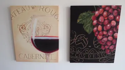 a book with a glass of red wine next to a bunch of grapes at CATALINA PORT & BEACH -3 dormitorios in Masnou