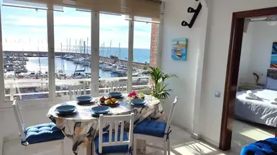 a dining room with a table and a view of the ocean at CATALINA PORT & BEACH -3 dormitorios in Masnou