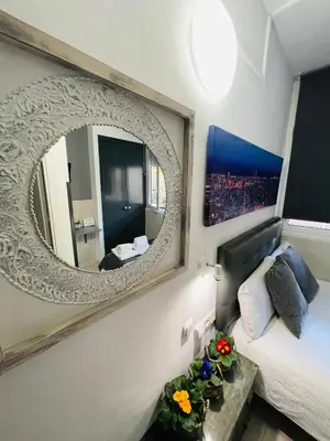 a bedroom with a large mirror on the wall at Hostal Lleida in Barcelona