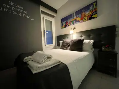 a bedroom with a bed with towels on it at Hostal Lleida in Barcelona