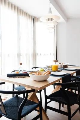 a table with chairs and a bowl of food on it at Petit Luxe l'Àtic in Terrassa