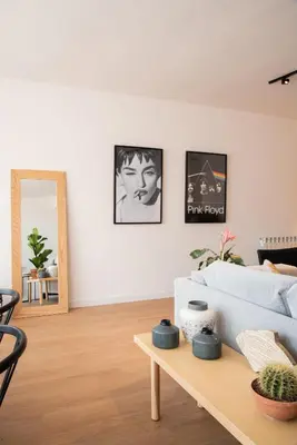 a living room with a couch and a table at Petit Luxe l'Àtic in Terrassa