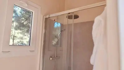a shower with a glass door in a bathroom at HolaCamp Sitges Garrofer in Sitges