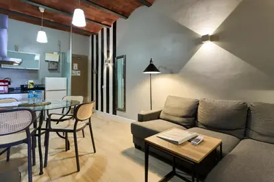 a living room with a couch and a table at Fira Apartments by gaiarooms in Barcelona