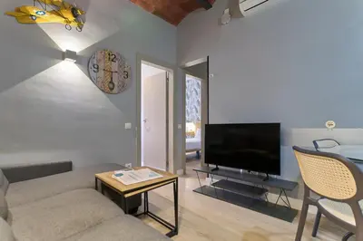 a living room with a couch and a tv at Fira Apartments by gaiarooms in Barcelona