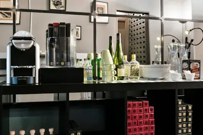 a counter with bottles and dishes on a shelf at Fira Apartments by gaiarooms in Barcelona