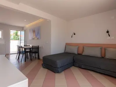 a living room with a bed and a table at Apartamentos Sunway Arizona in Sitges