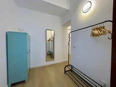 a room with a blue cabinet and a mirror at BarcelonaForRent Sant Pau Suite in Barcelona