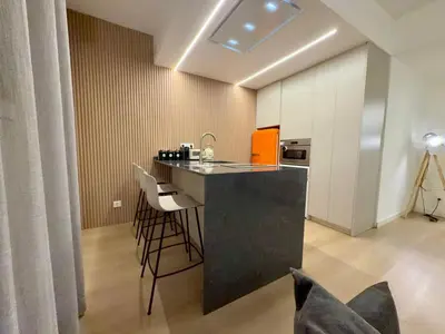 a kitchen with a counter and stools in a room at BarcelonaForRent Sant Pau Suite in Barcelona