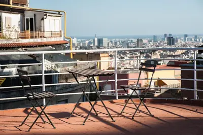 two chairs and a table on top of a balcony at Casa Vilaró Park Guell in Barcelona