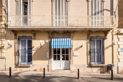 a building with a white door and a balcony at Hotel Medium Renaixença in Sitges