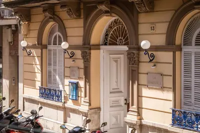a building with windows and scooters parked in front of it at Hotel Medium Renaixença in Sitges