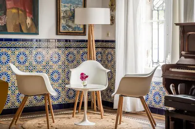 a room with three chairs and a table and a lamp at Hotel Medium Romantic in Sitges