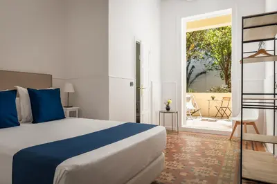 a hotel room with a bed and a balcony at Hotel Medium Romantic in Sitges