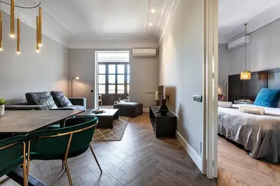a room with a bed and a table and a couch at Weflating City Center in Barcelona