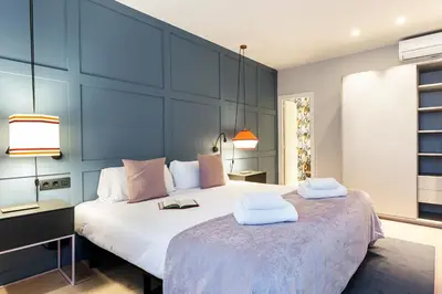 a bedroom with a large bed with two towels on it at Weflating City Center in Barcelona