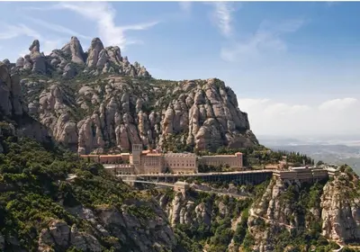 a mountain with a monastery on top of it at Raco de Lis in La Torre de Claramunt