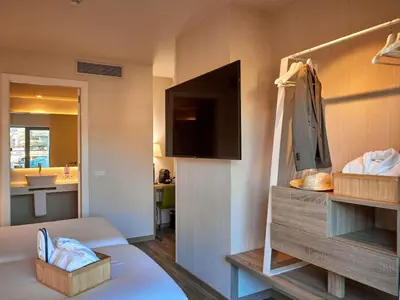 a room with a bed and a tv and a bathroom at Mercure Barcelona Condor in Barcelona