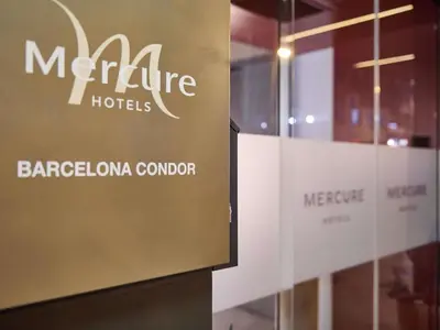a sign for a hotel in front of a window at Mercure Barcelona Condor in Barcelona