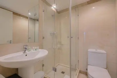 a bathroom with a toilet and a sink and a shower at Rent Top Apartments Beach-Diagonal Mar in Barcelona