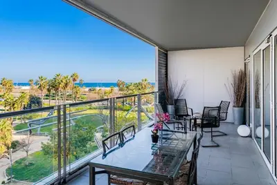 a balcony with a table and chairs and a view of the ocean at Rent Top Apartments Beach-Diagonal Mar in Barcelona