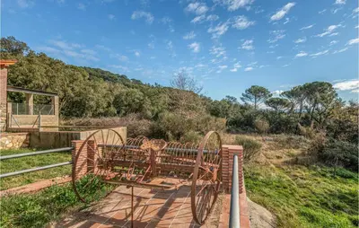 a wooden bench sitting on top of a hill at 4 Bedroom Nice Home In Riells I Viabrea in Breda