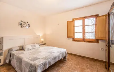 a bedroom with a bed and a window at 4 Bedroom Nice Home In Riells I Viabrea in Breda