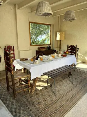 a dining room with a white table and chairs at Mas Palou in Pla del Panadés