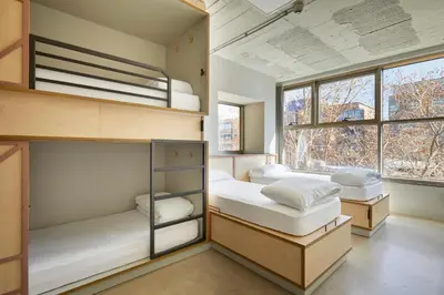 two bunk beds in a room with a window at Unite Hostel Barcelona in Barcelona