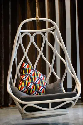 a white chair with two pillows in it at Generator Barcelona in Barcelona
