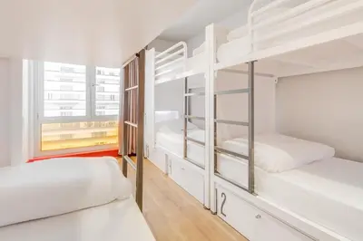 a room with two bunk beds and a window at Generator Barcelona in Barcelona