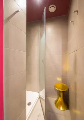a bathroom with a shower with a yellow toilet at Generator Barcelona in Barcelona