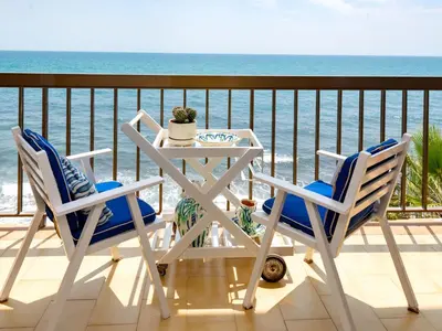 a table and chairs on a balcony overlooking the ocean at Apartment Acuario by Interhome in Sant Andreu de Llavaneres