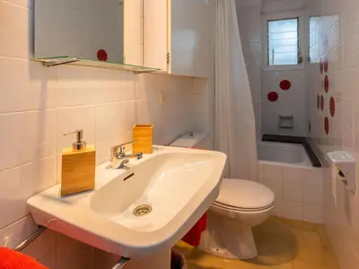 a white bathroom with a sink and a toilet at Apartment Acuario by Interhome in Sant Andreu de Llavaneres