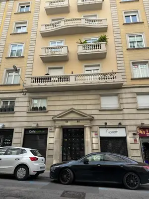 a black car parked in front of a building at Pensión Laforja in Barcelona
