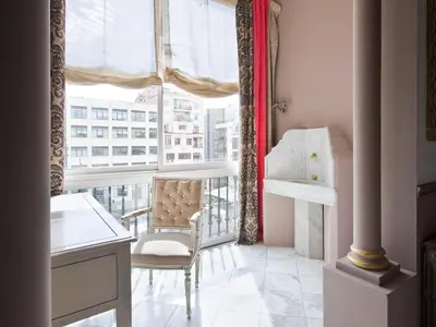 a room with a window with a chair and a table at HoHomes - Centric Design Apartment in Barcelona