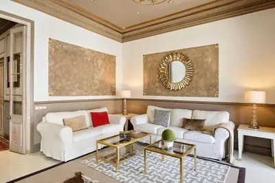 a living room with two white couches and a mirror at HoHomes - Centric Design Apartment in Barcelona