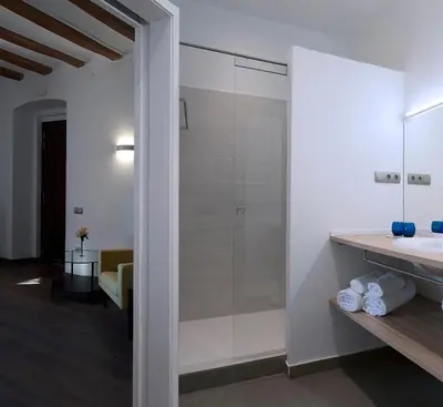 a bathroom with a glass shower and a sink at La Frasera Alojamiento Rural in Vacarisas