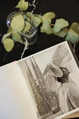 a black and white photo of a woman and a vase with flowers at Maldà Singular Hotel in Barcelona