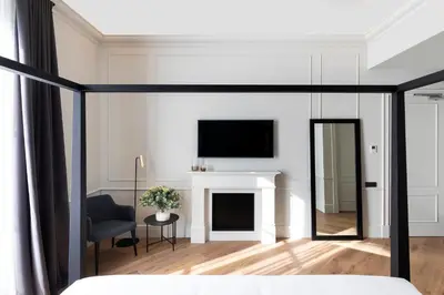 a bedroom with a fireplace and a tv on the wall at Maldà Singular Hotel in Barcelona